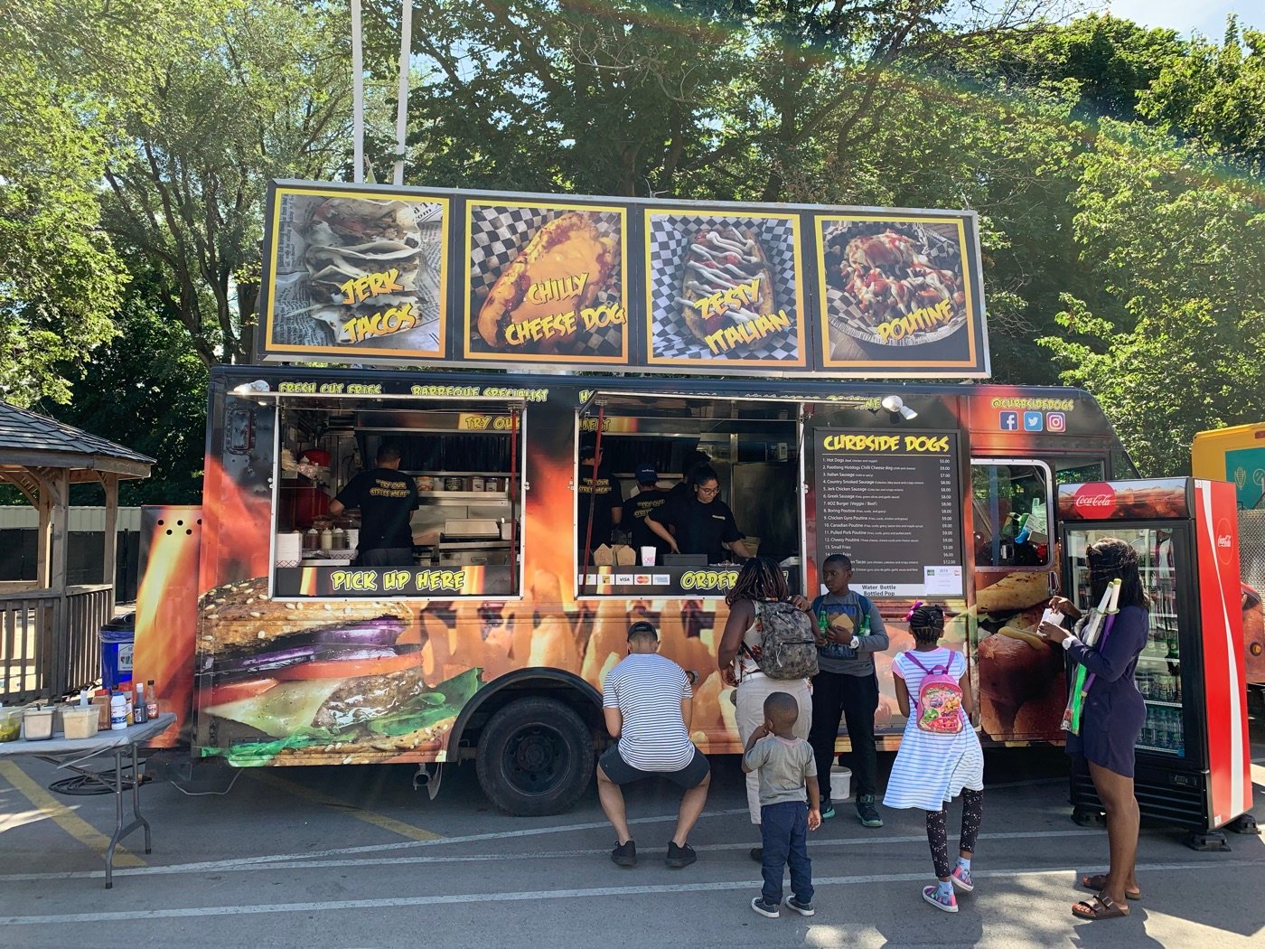 Curbsidedogs truck serving guests at a park event